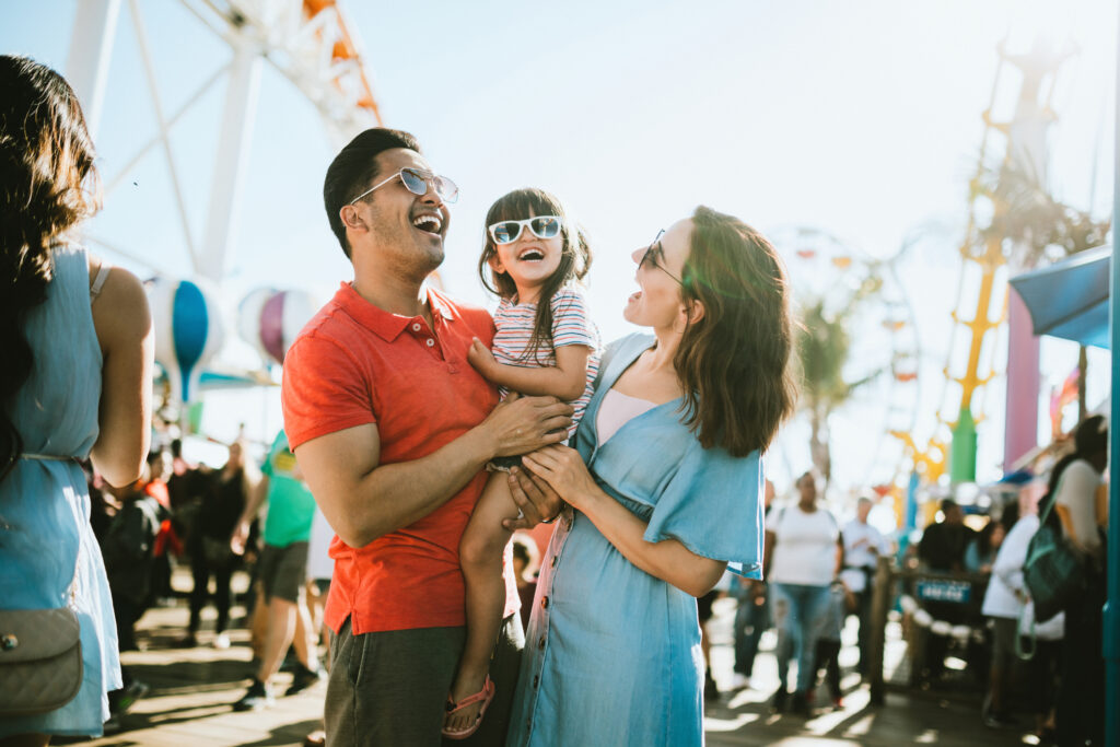 A family enjoys the rides and sun at the fair activities